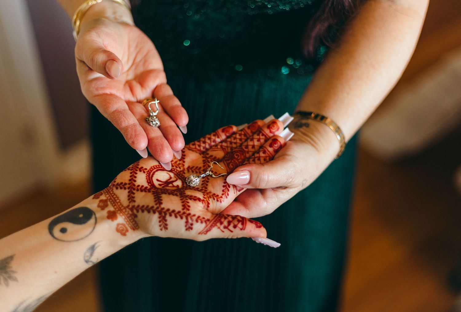Close-up shots of hands showing intricate henna designs.