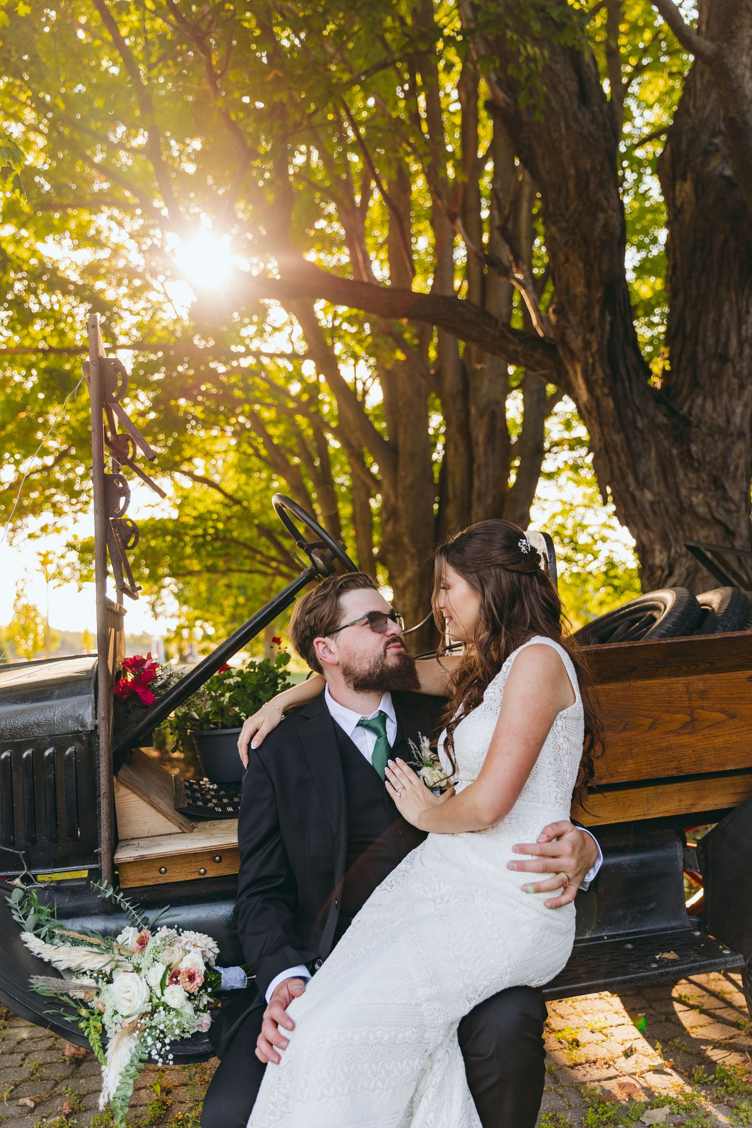 Romantic sunset portraits of newlyweds against golden-lit trees.