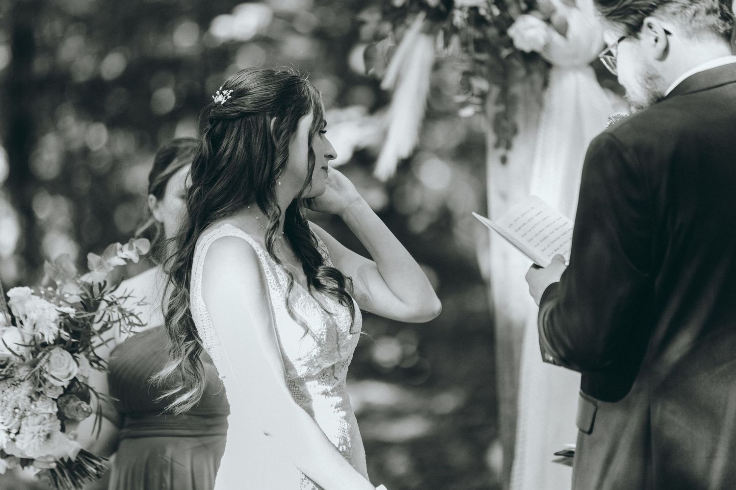 Black and white emotional moments during forest wedding ceremony.