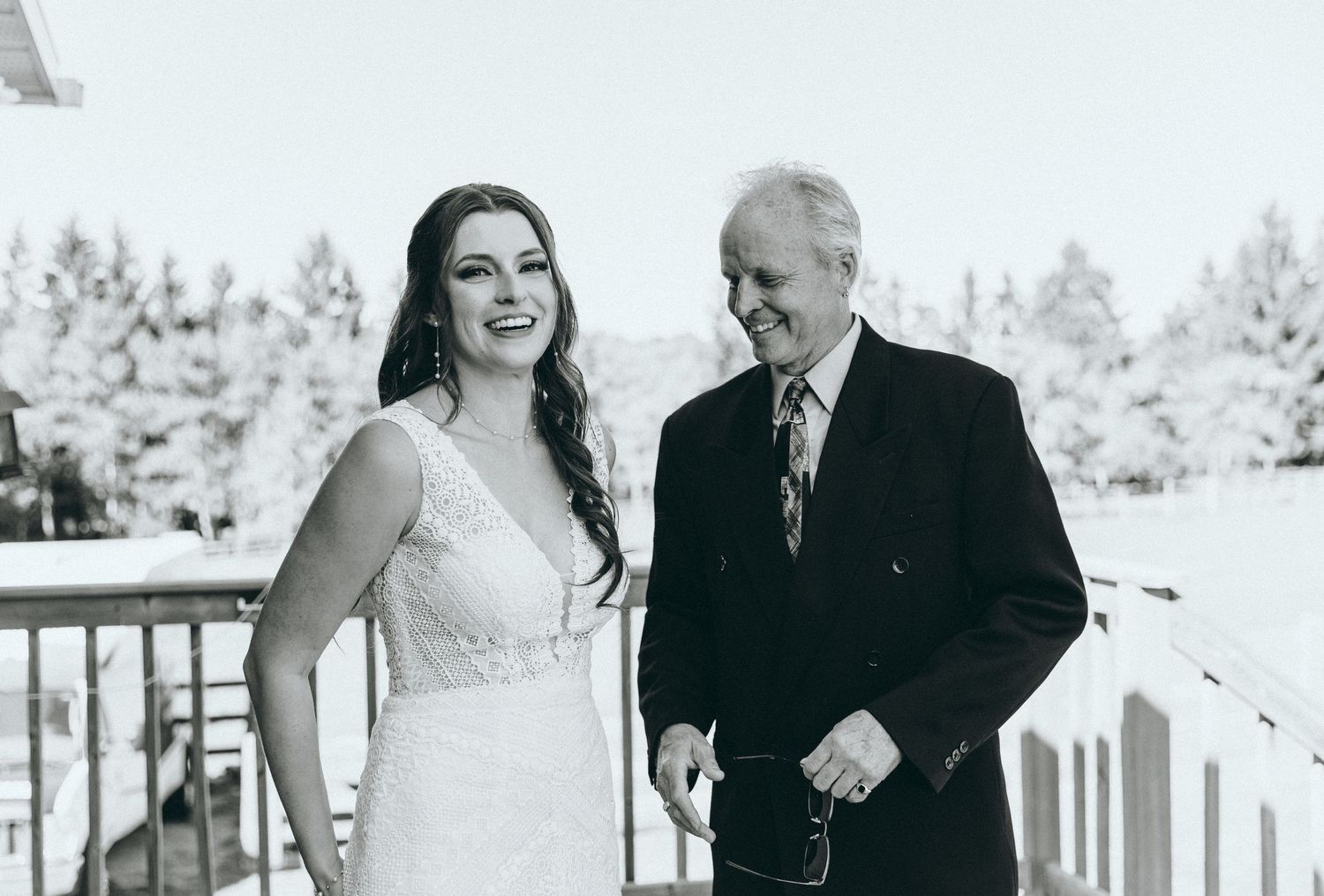 Black and white portraits of couple sharing intimate moments on deck.