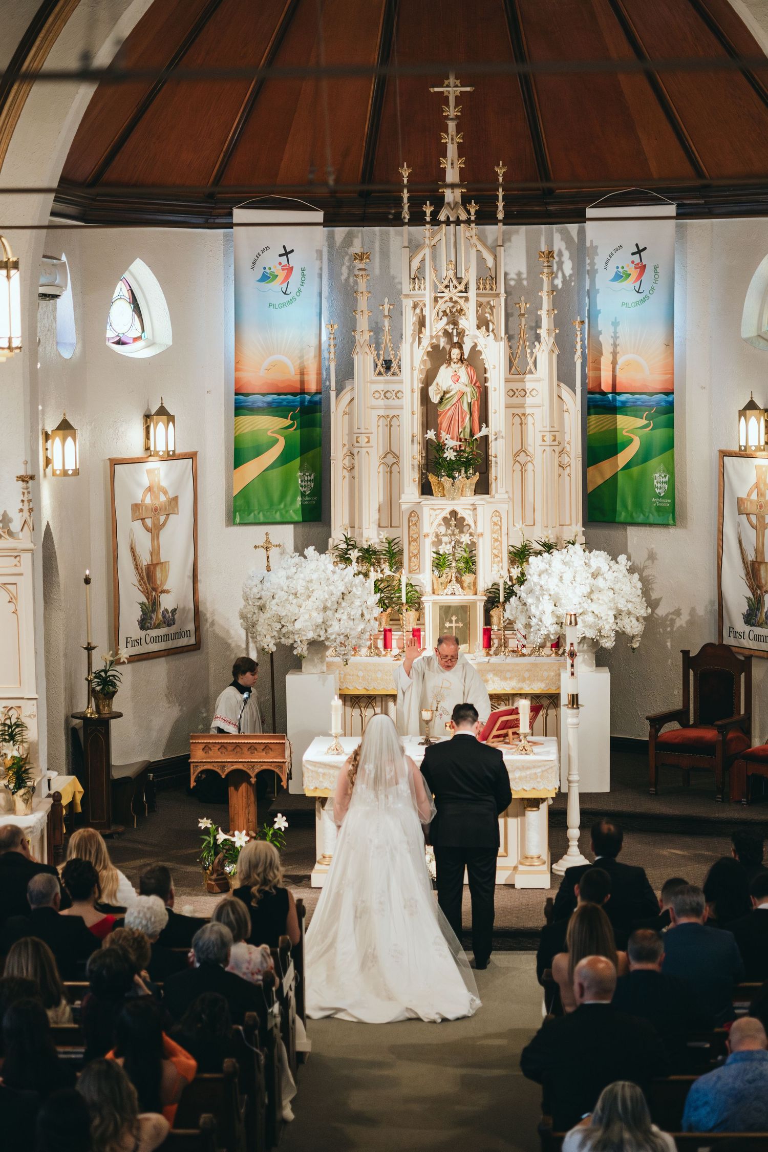 Traditional church wedding ceremony with ornate altar and stained glass windows.