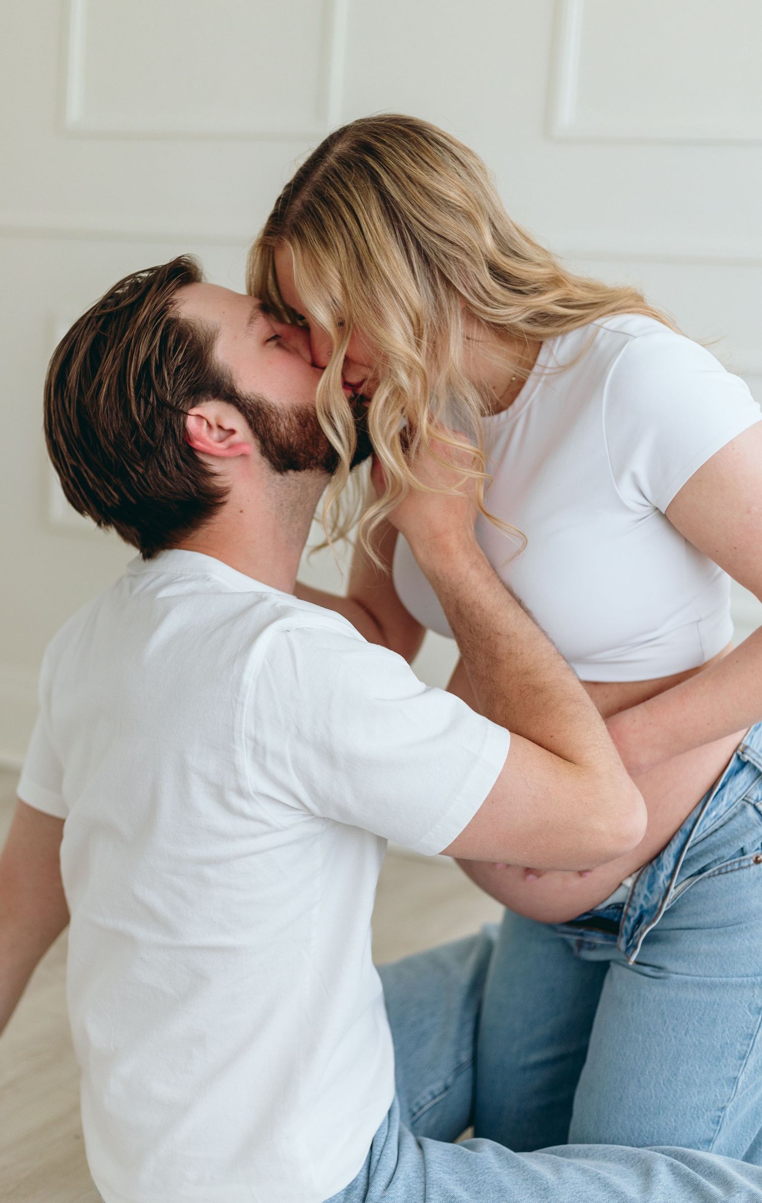 Romantic sequence of a couple sharing intimate moments while wearing casual white tops and jeans.
