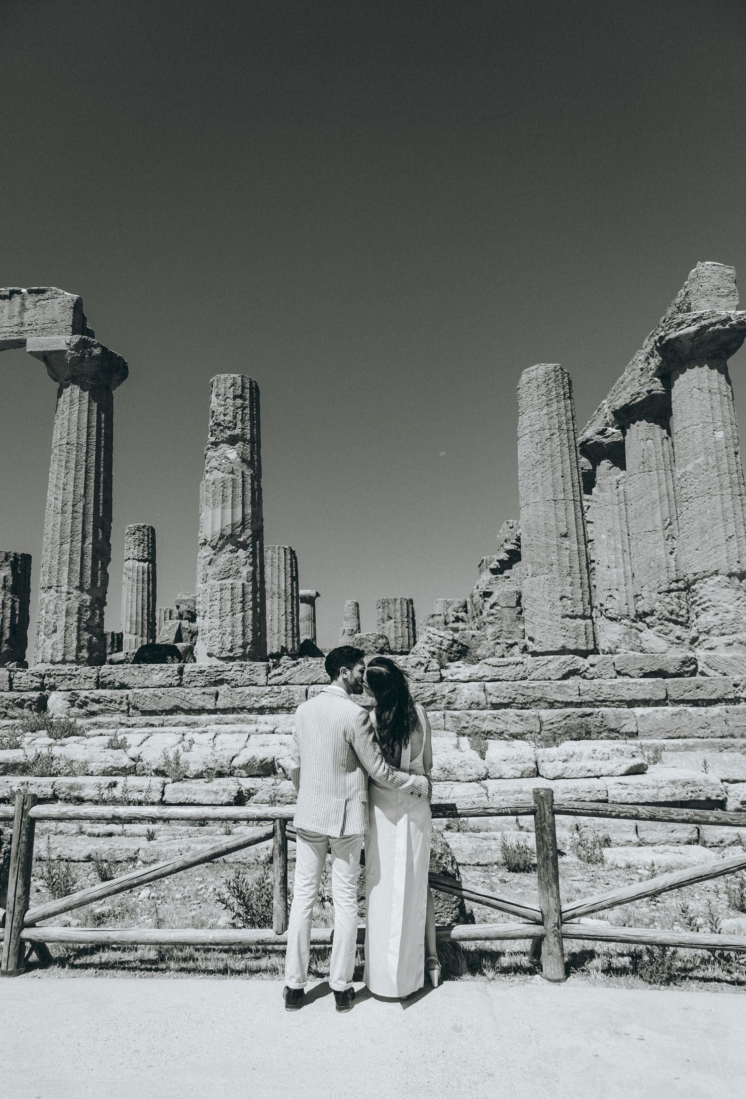 Black and white panorama of classical Greek temple ruins with stone columns.