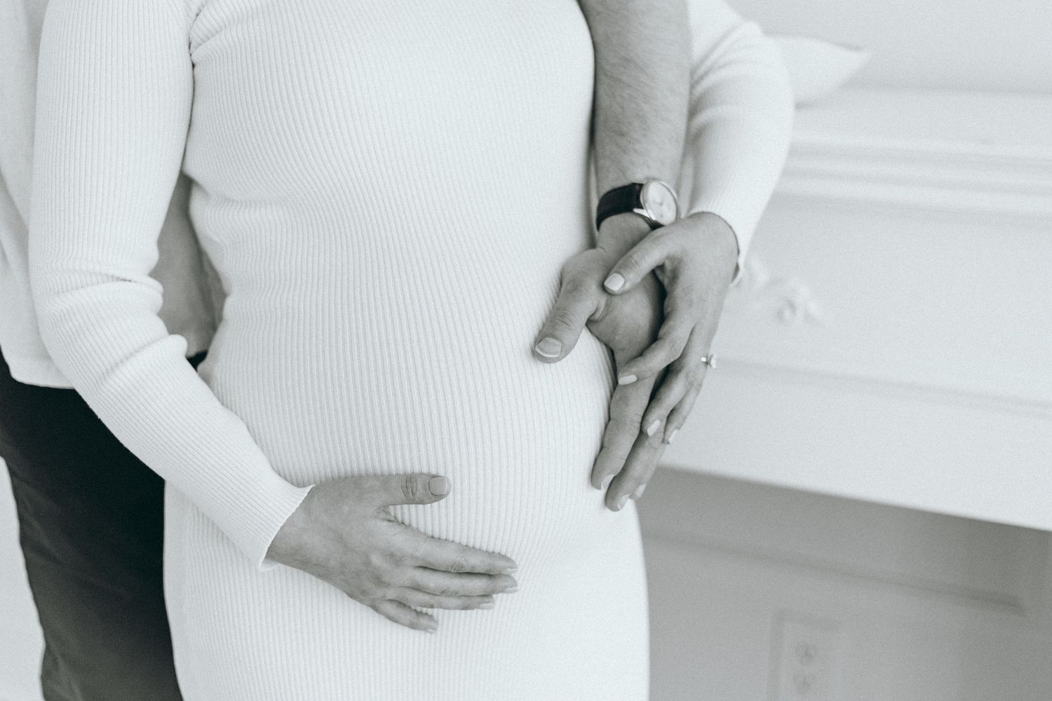 Simple white-on-white maternity portraits showing pregnancy progression.