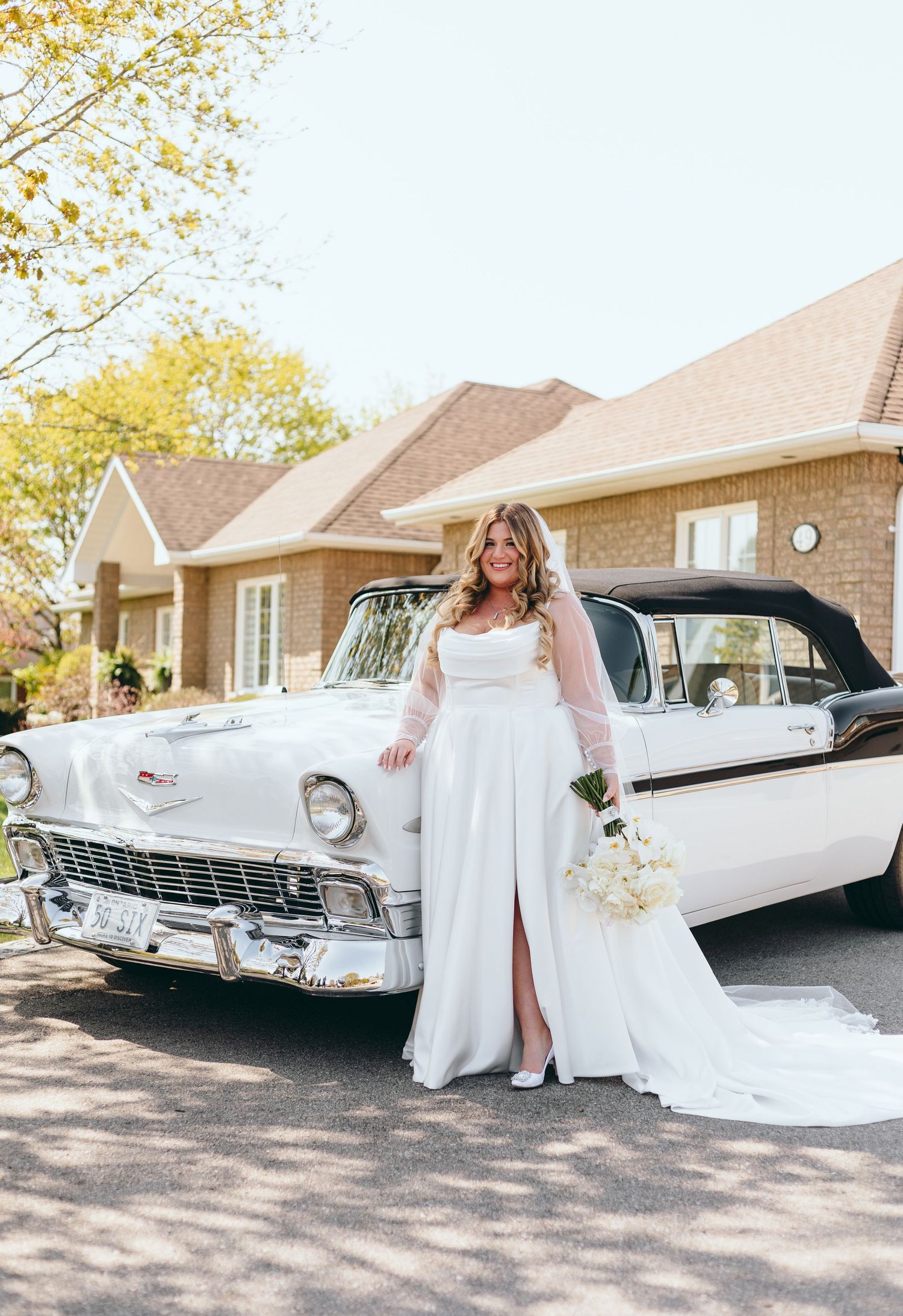 Classic white cars lined up for a wedding photoshoot on a sunny autumn day.
