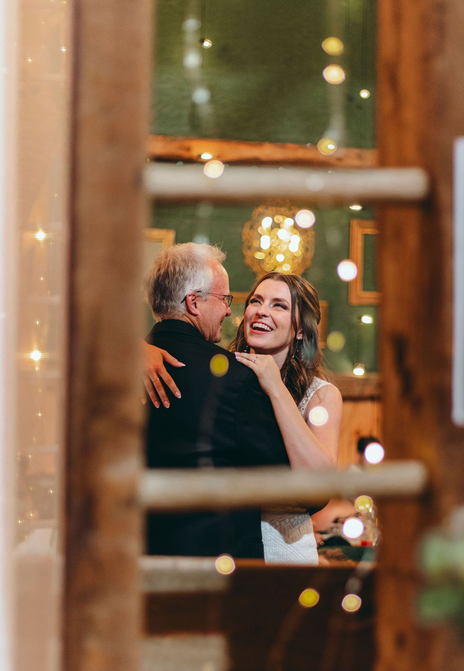 Wedding reception scene with twinkling lights and elegant indoor decor.