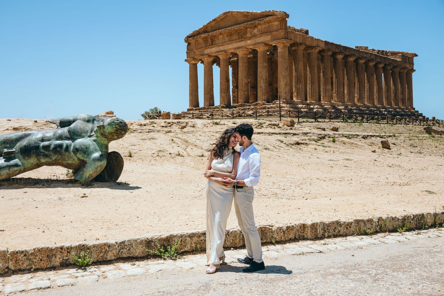 Romantic photoshoot at the Valley of Temples with ancient Greek architecture in background.