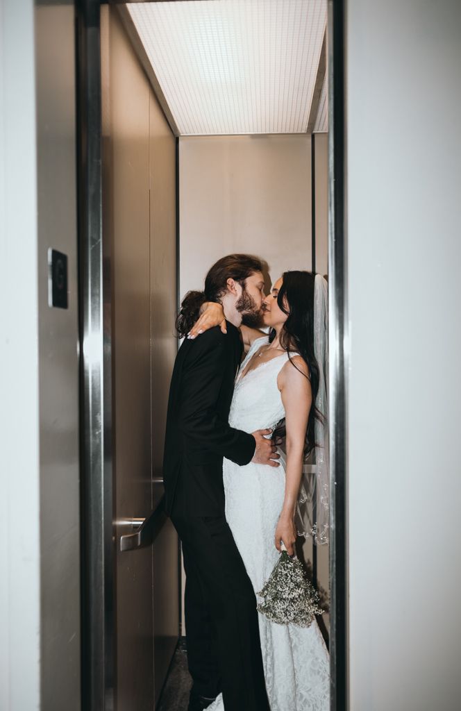 Intimate wedding moments captured in a modern elevator hallway.