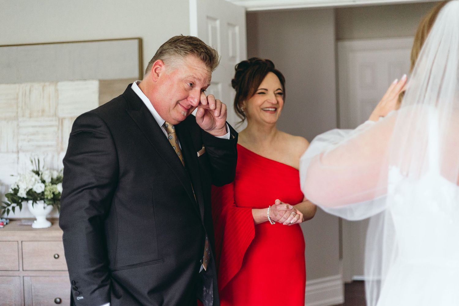 First look wedding moment captured in modern indoor setting.