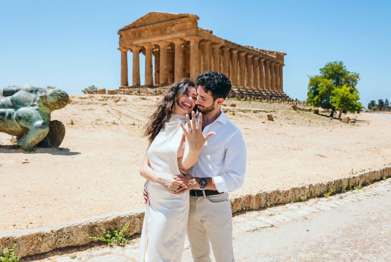 Sunny engagement photos at historic Temple of Concordia in Agrigento, Sicily.