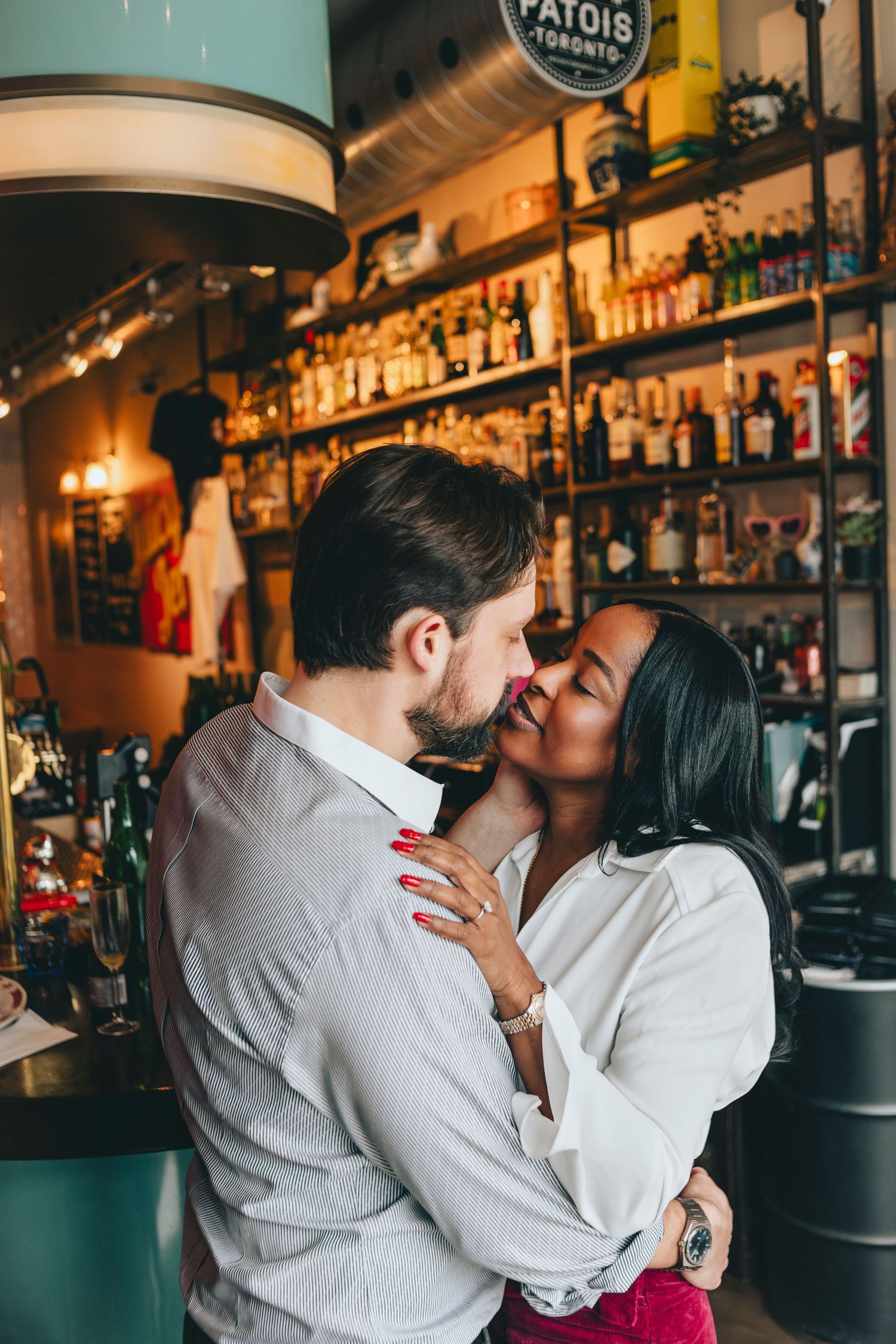 Intimate moment captured at a bar with ambient lighting.