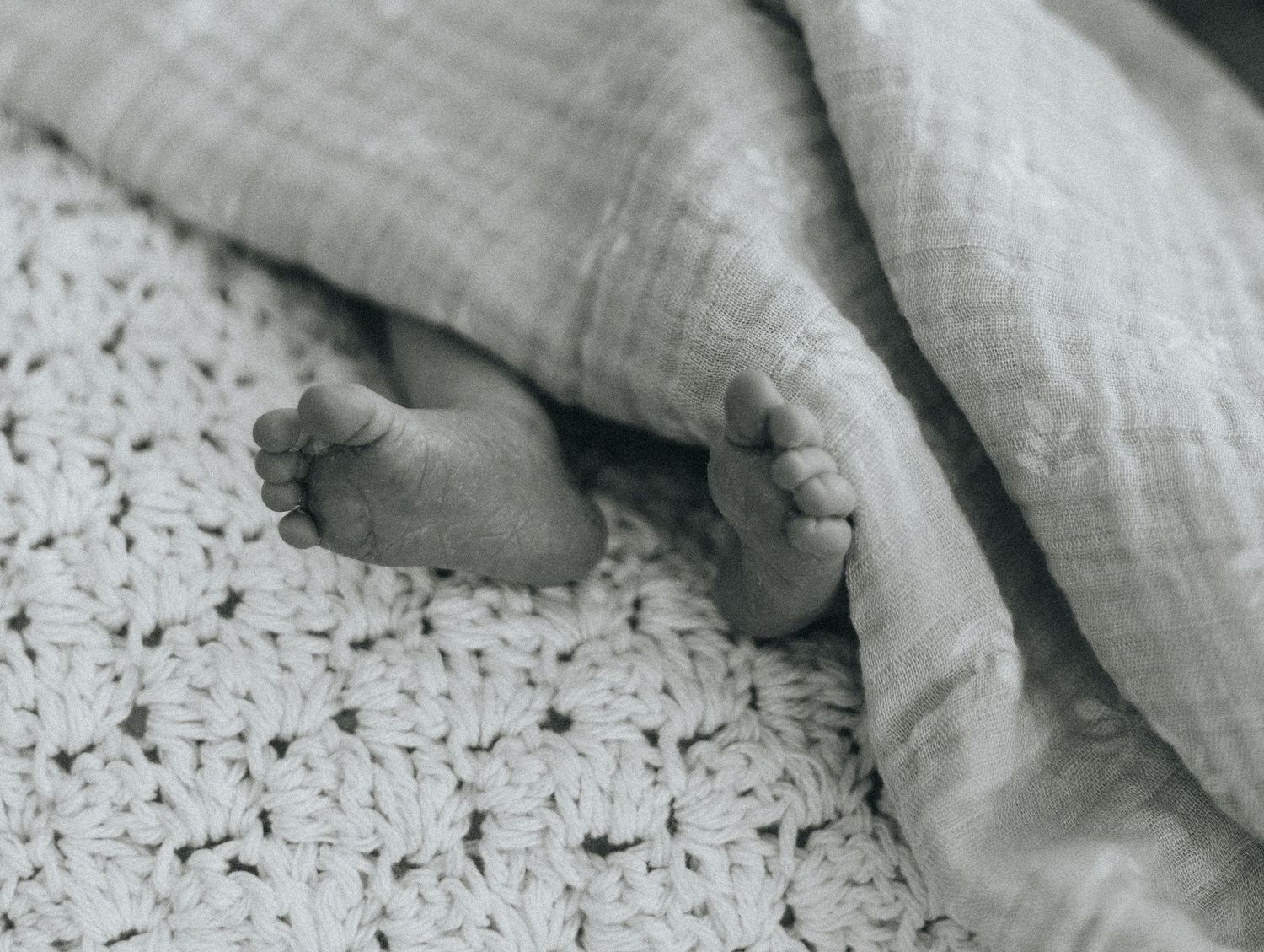 Minimalist black and white detail shots of fabric textures and gentle movements.