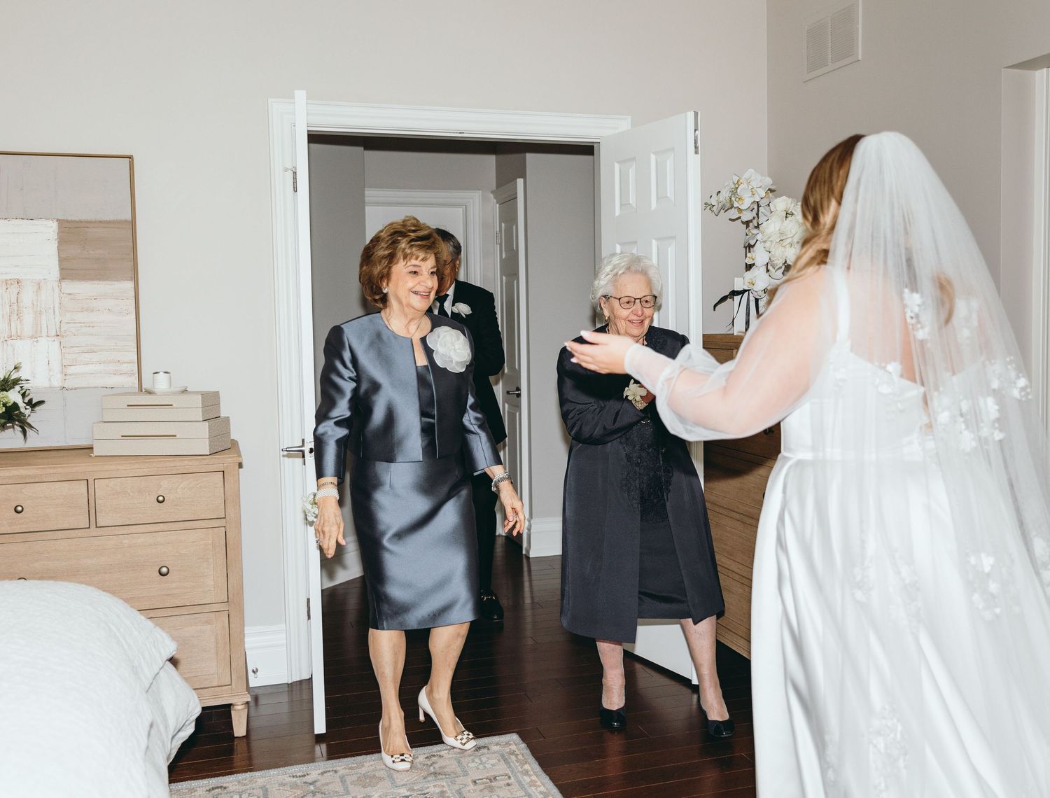 Wedding preparation moments captured in bright indoor setting with natural light.