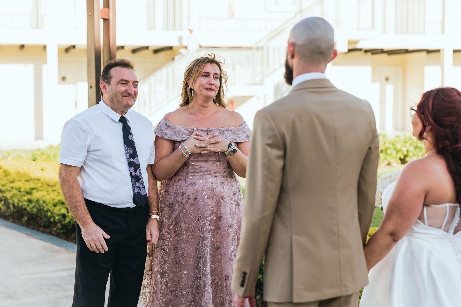 Wedding party members gather during outdoor reception.