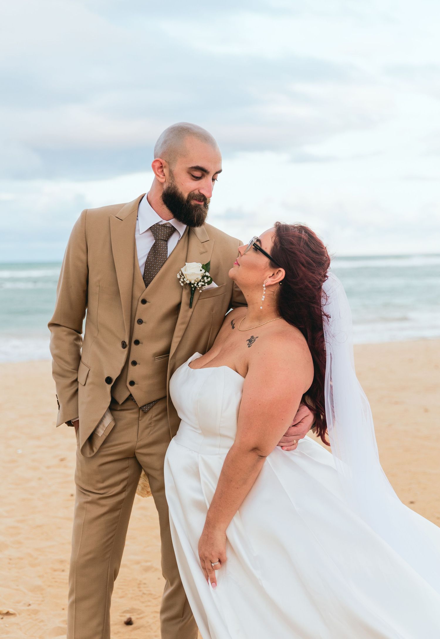 Romantic beach wedding photos with ocean waves in the background.