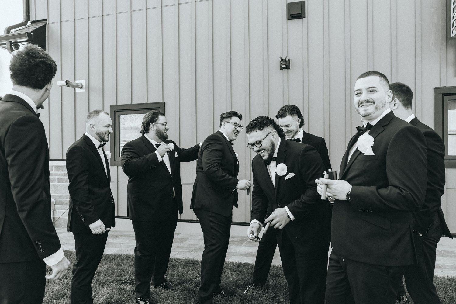 Candid moments of groomsmen laughing and interacting in formal attire outdoors.