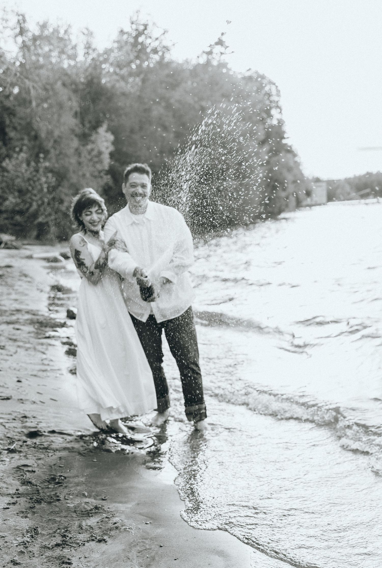 Black and white beach photos showing playful moments near the water.