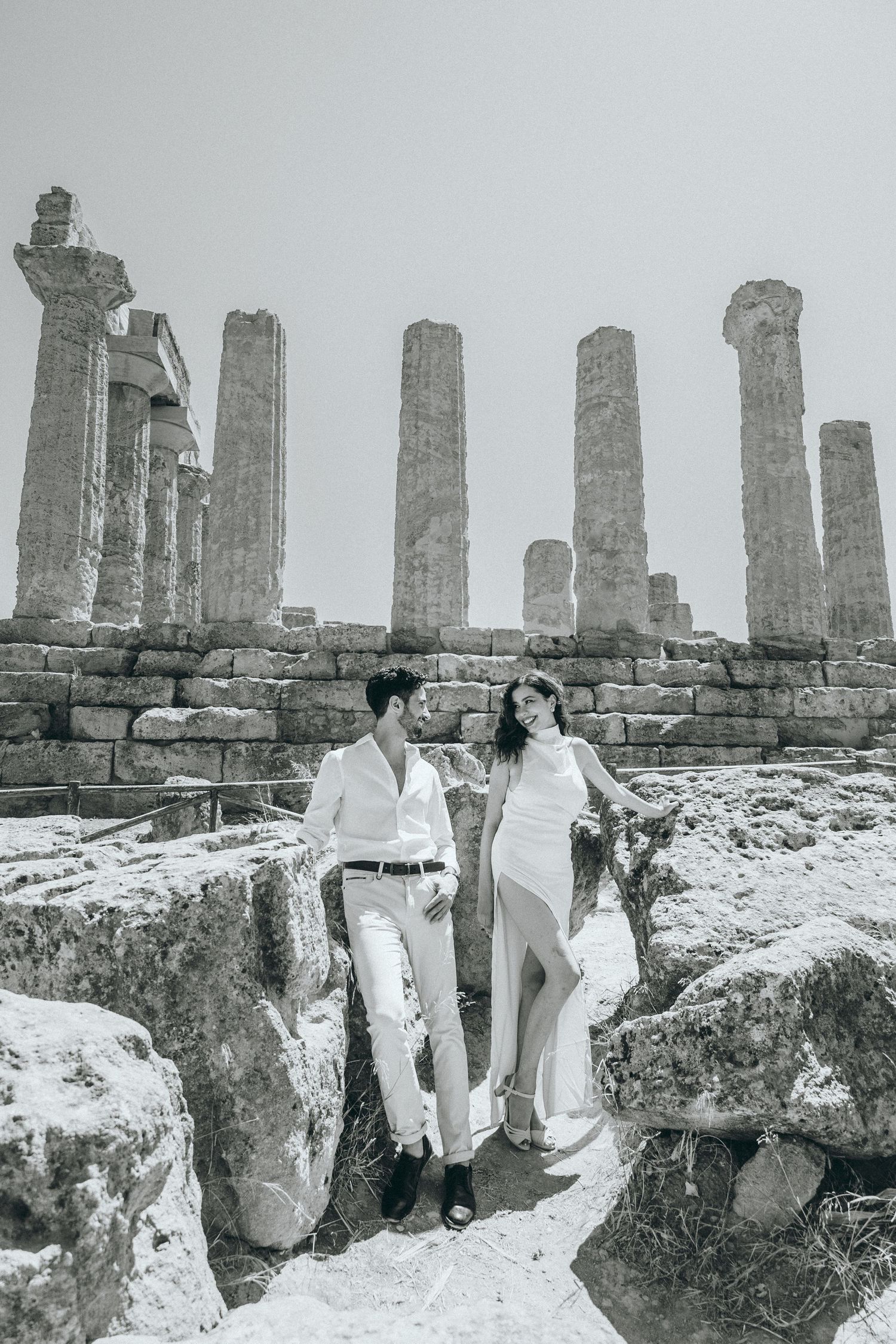 Ancient stone ruins and columns create a dramatic backdrop at a historical archaeological site.