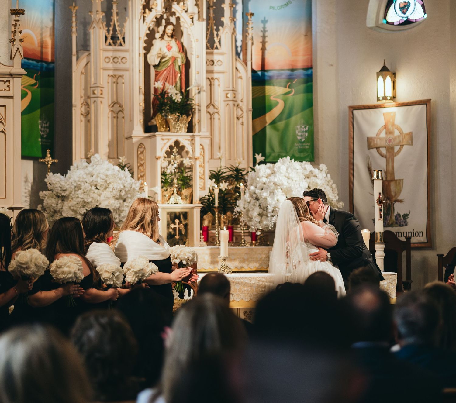 Interior of a grand church filled with wedding guests during a ceremony.