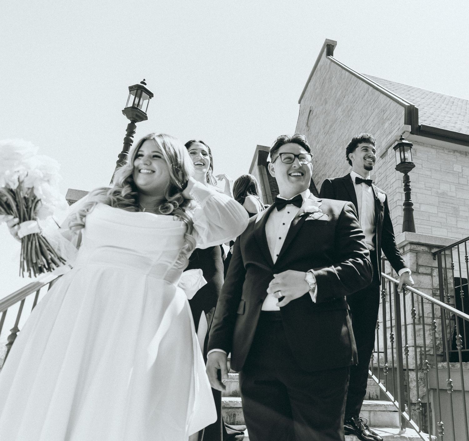 Black and white candid shots of wedding party celebrating outdoors.