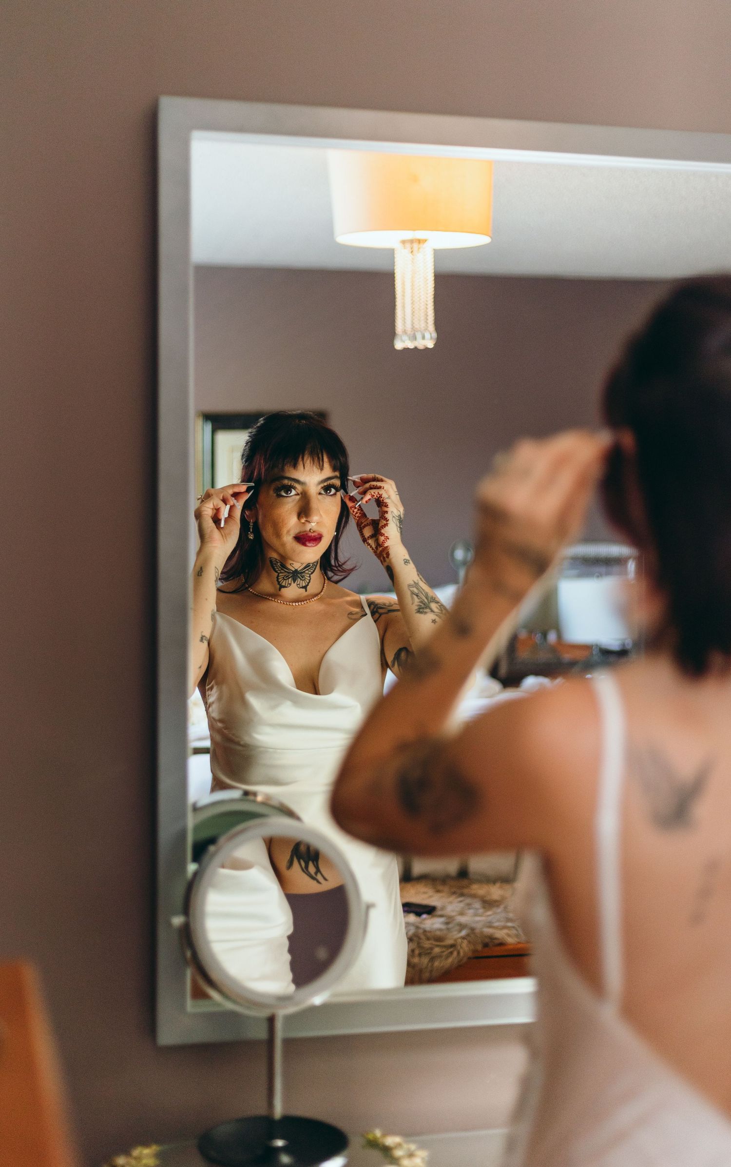 Wedding preparation sequence showing person in white dress looking in mirror while getting ready.