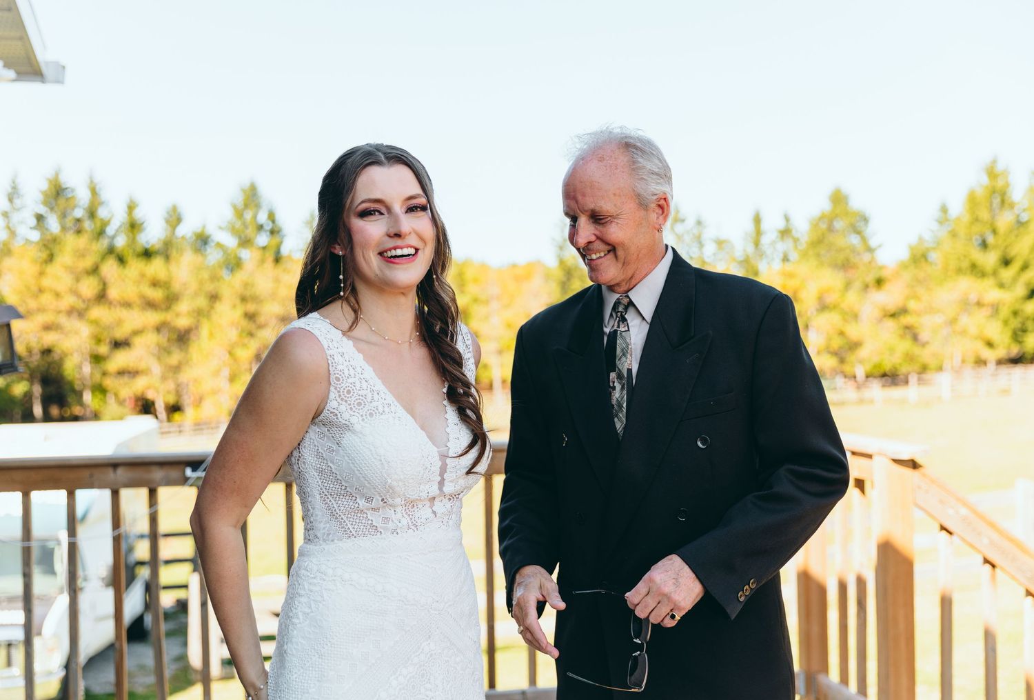 A couple dances together on an outdoor deck during golden hour.