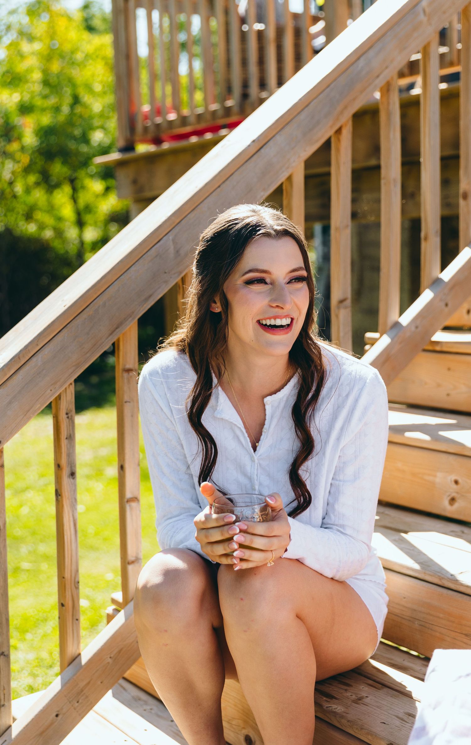 White wooden deck stairs in bright sunlight during a summer day.