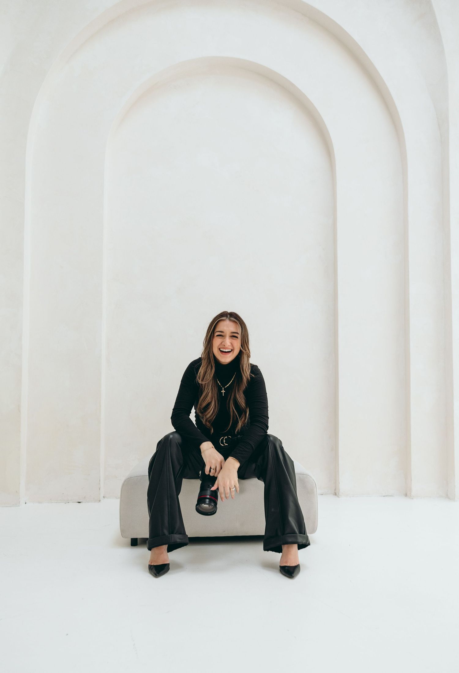 Creative portrait session in a white arched architectural setting.