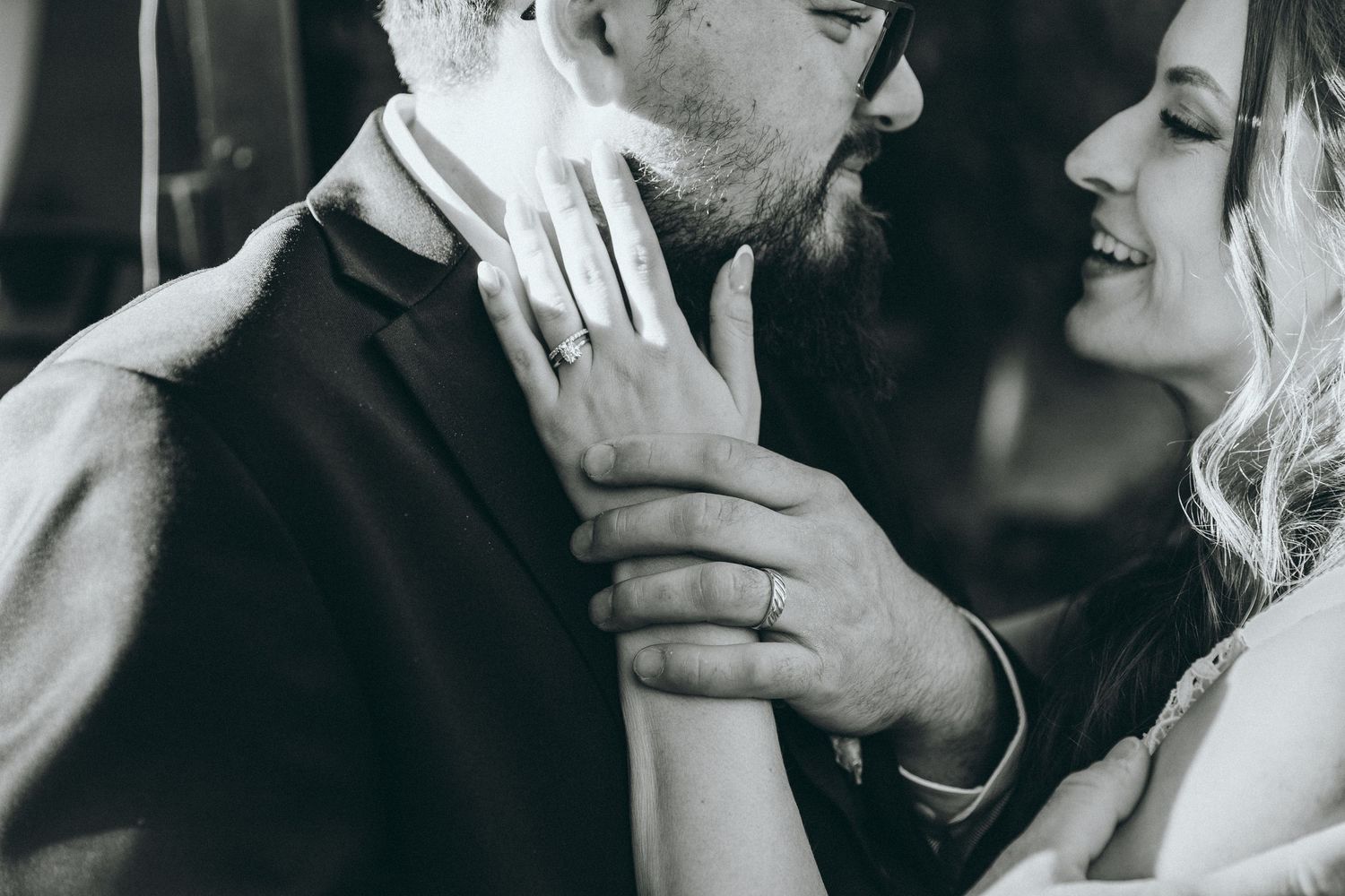 Intimate black and white close-up shots of a tender wedding moment.