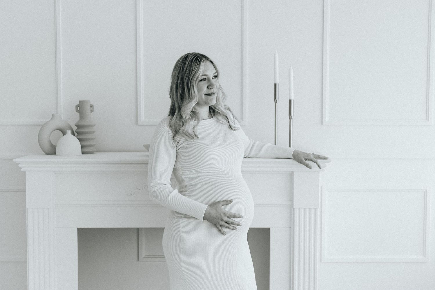 Modern maternity session in bright white room with classic architectural details.