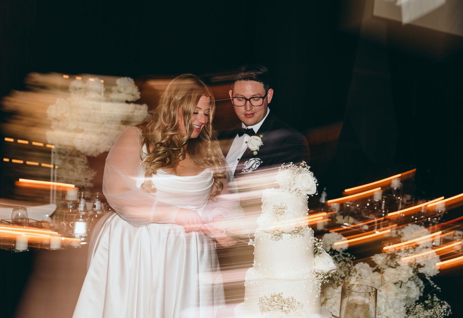 Wedding reception venue with elegant lighting and decor details.