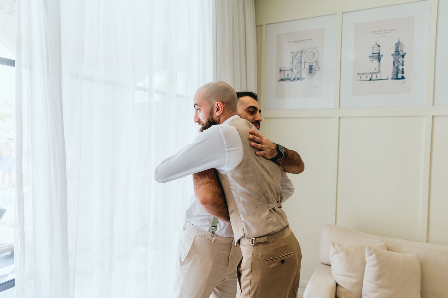 Groomsmen in formal attire having fun and posing playfully in a bright indoor setting.
