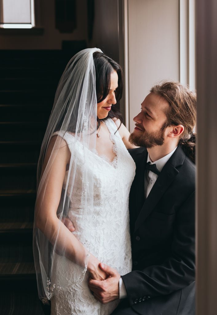 Romantic indoor wedding portraits with soft natural lighting.