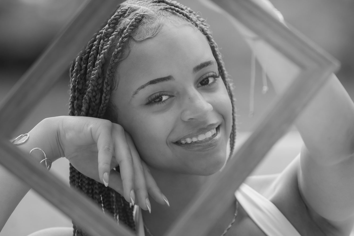Close-up portrait series showing joyful expressions and braided hairstyle.