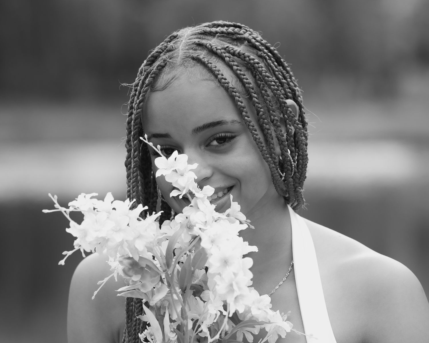 Portrait series with braided hair and white flowers in black and white.