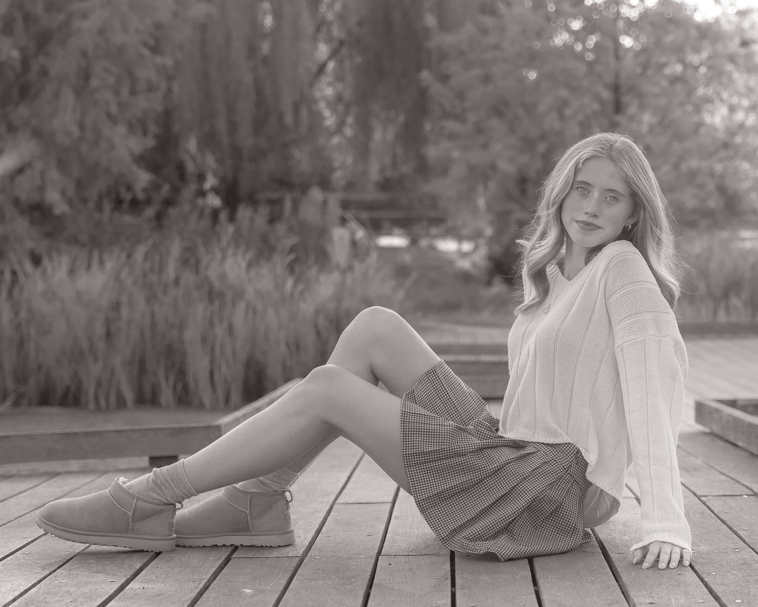 Dreamy monochrome portraits on wooden deck with soft focus and natural light.