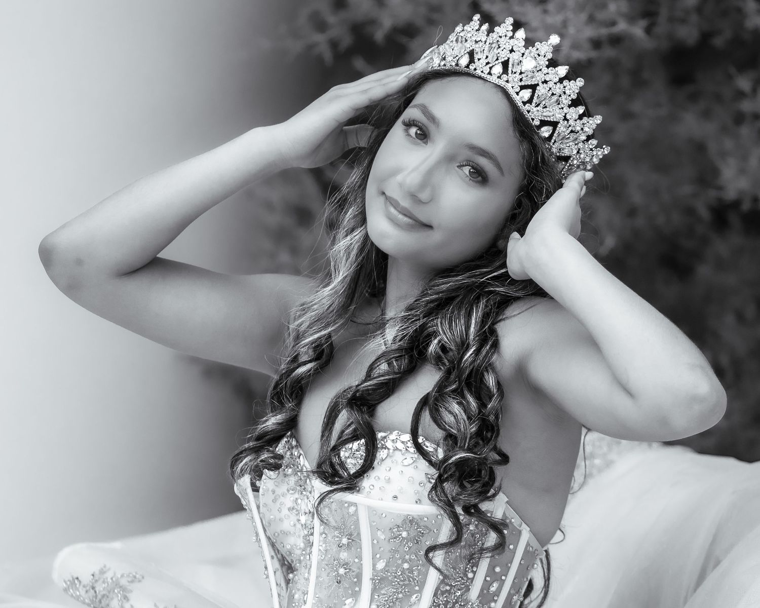 Portrait series showing person wearing ornate crown in elegant black and white photos.
