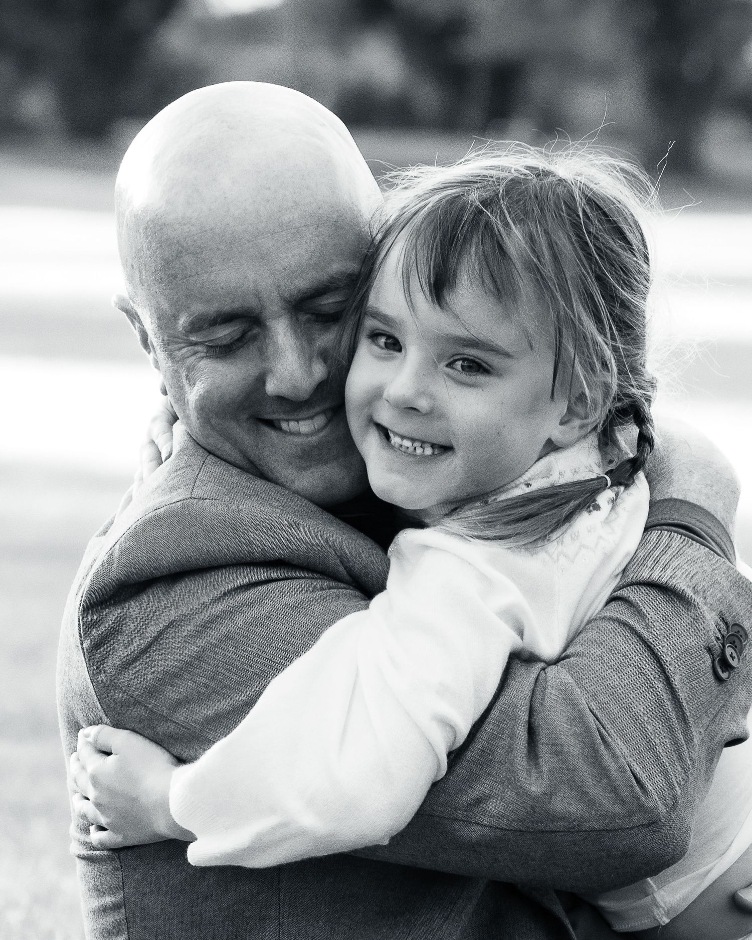 Black and white series capturing tender moments between family members embracing.