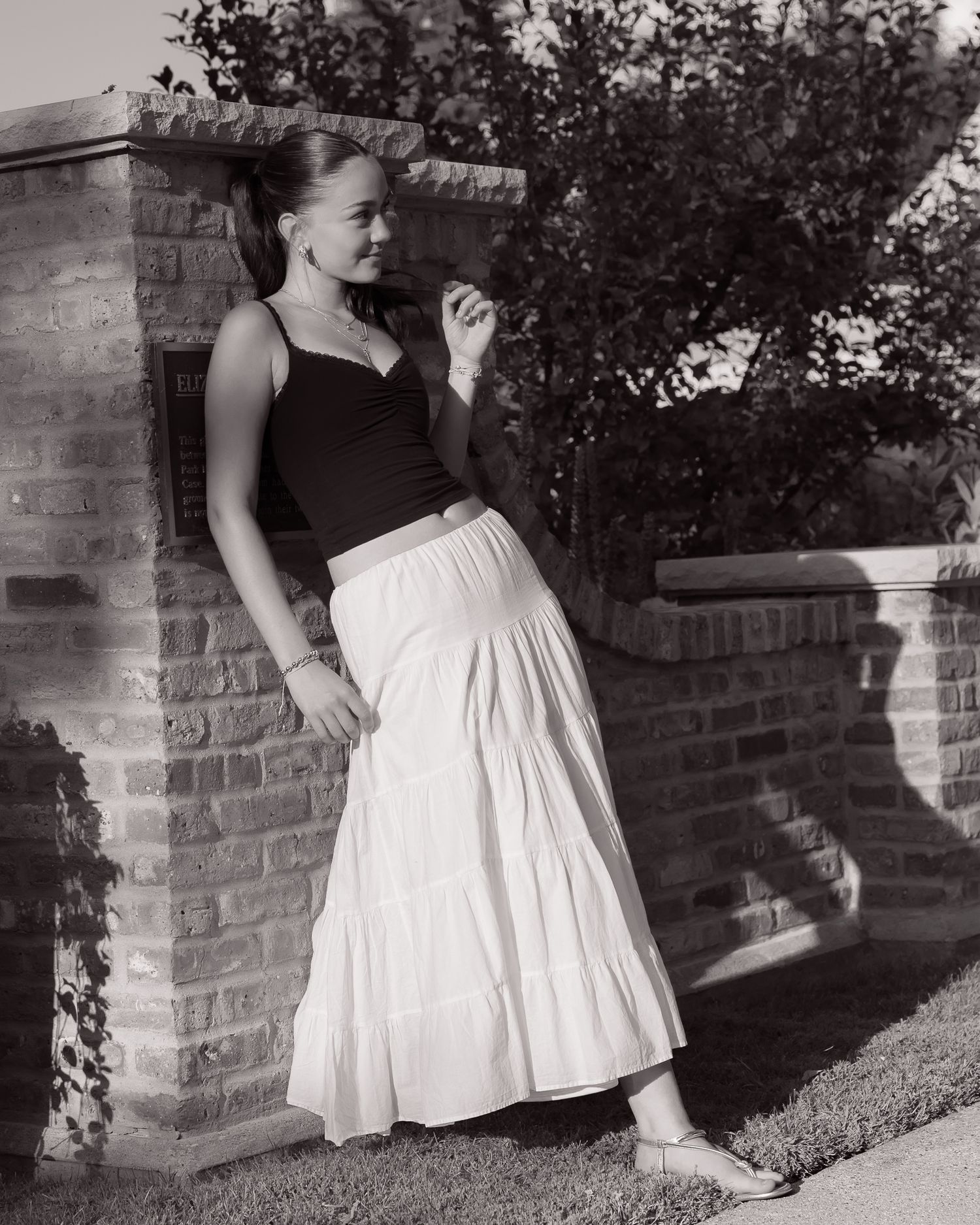 Black and white portraits featuring contrasting dark and white clothing against brick wall.