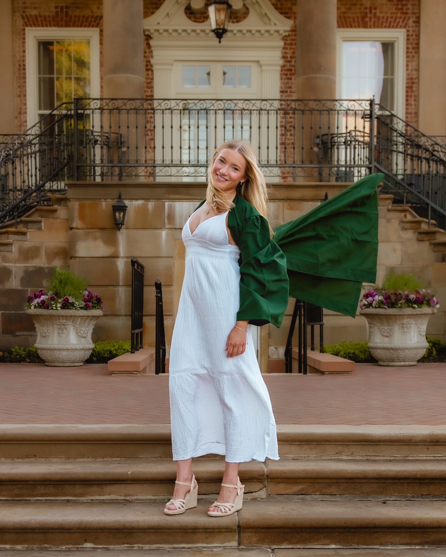 Senior in white dress with green class stole on the Cantigny mansion steps