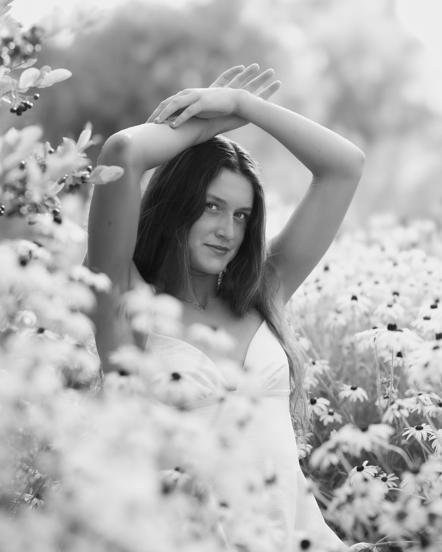 Artistic black and white portrait series among blooming flowers.