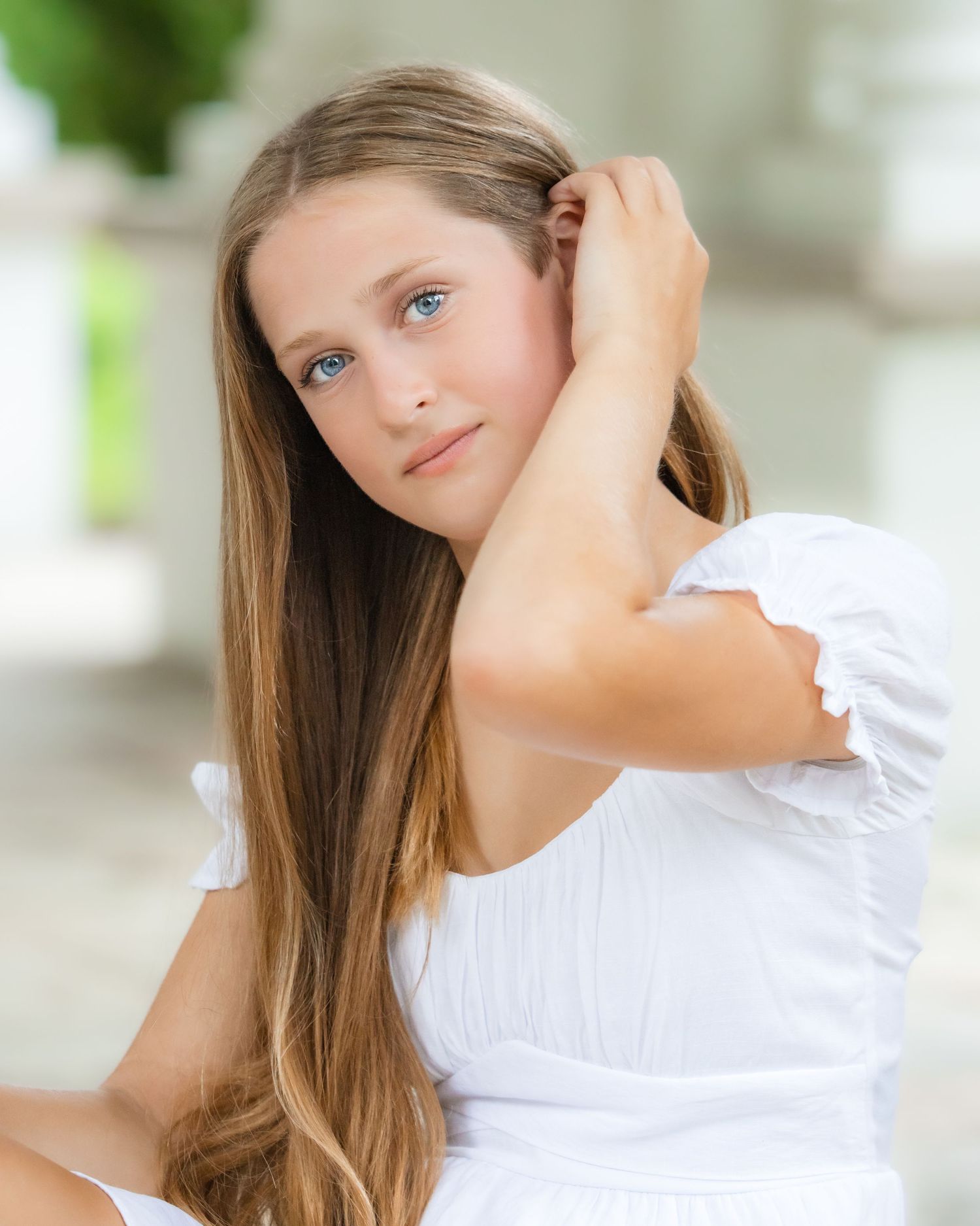 Portrait series featuring someone in a white ruffled top against a light background.