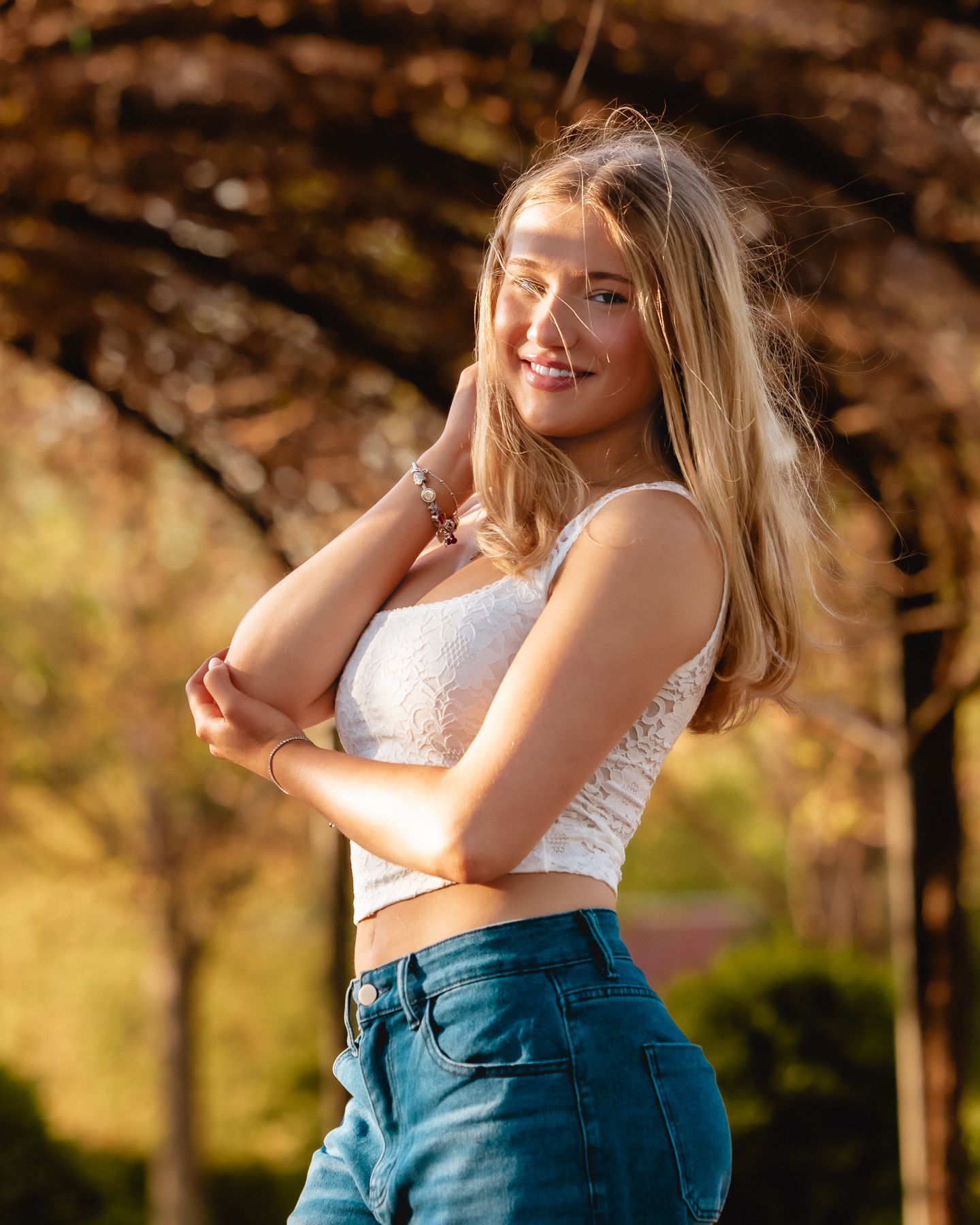 Senior with sunlit hair backlit by golden hour light at Cantigny