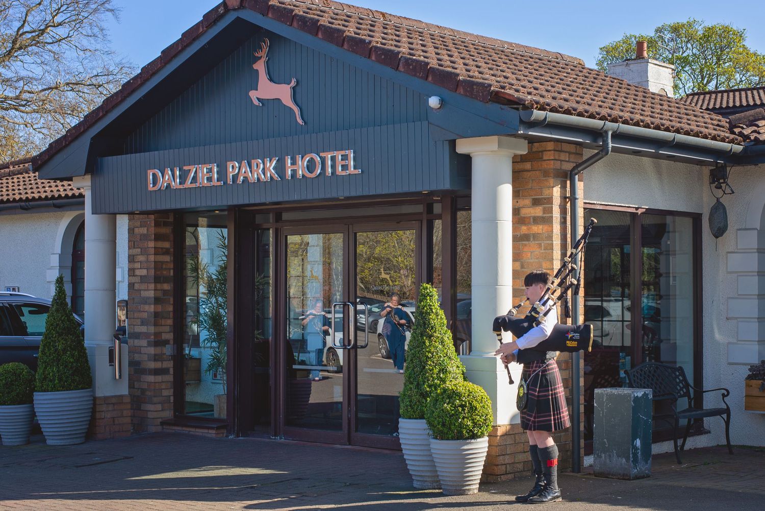 Exterior view of the Dalzel Park Hotel building with brown brick facade.