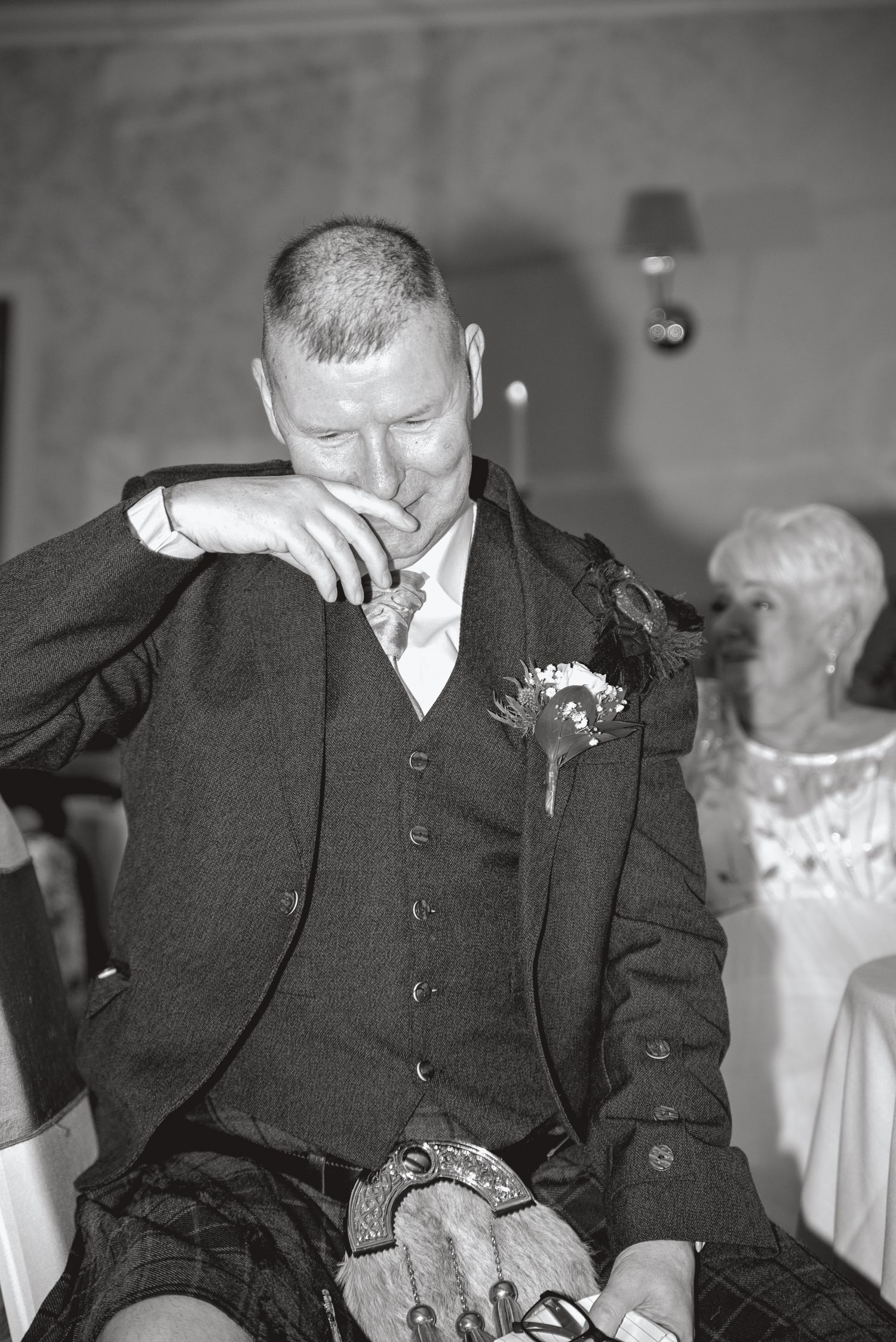 Black and white candid shots of guests during emotional wedding reception moments.