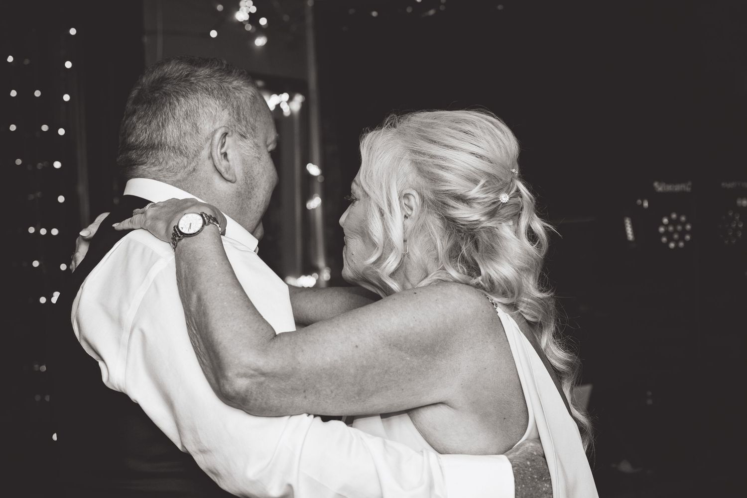 Black and white photos capture intimate dancing moments at a wedding reception.