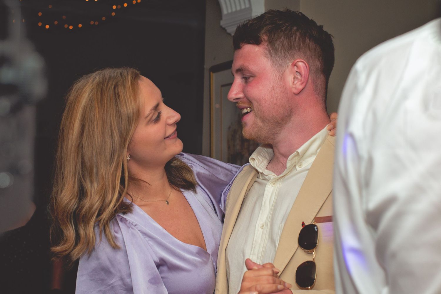 Wedding celebration with couples dancing close together during reception.