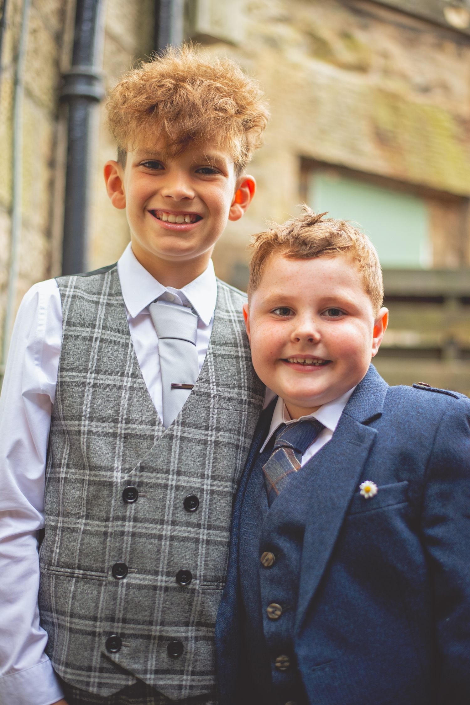 Two young attendees in formal attire at a wedding event.