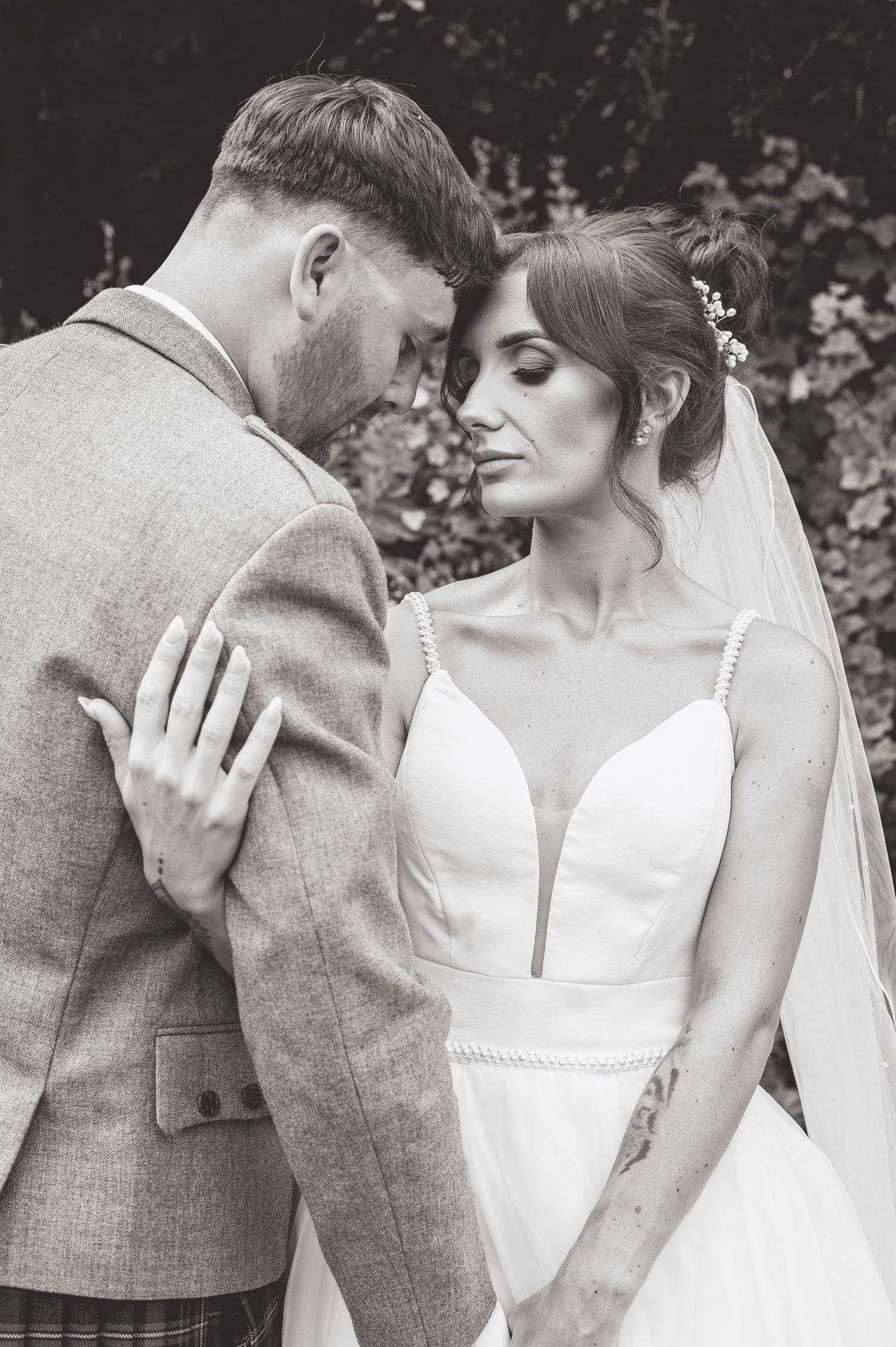 Black and white intimate wedding portraits showing tender moments between newlyweds.