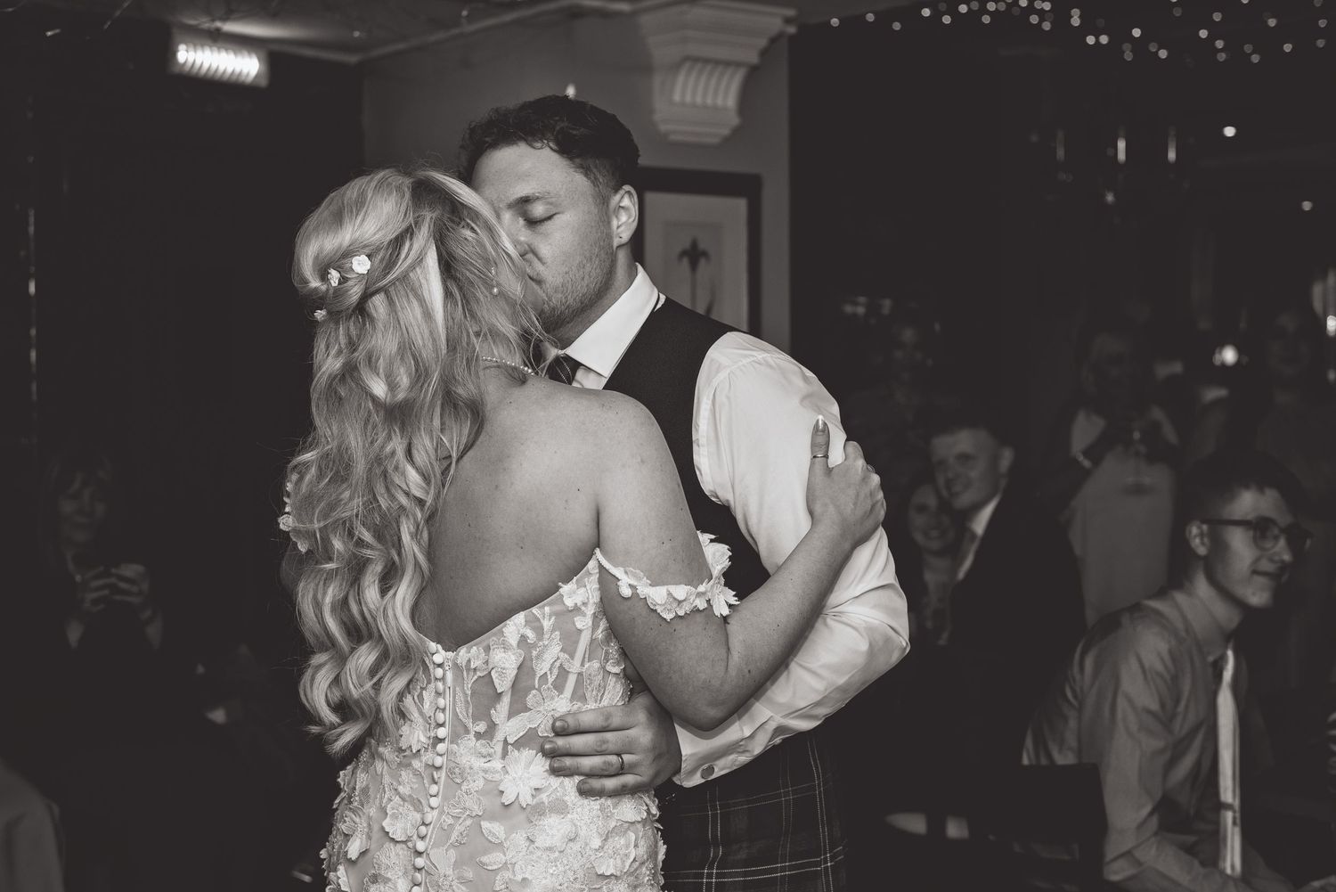 Black and white sequence shows romantic dance floor moments at wedding reception.